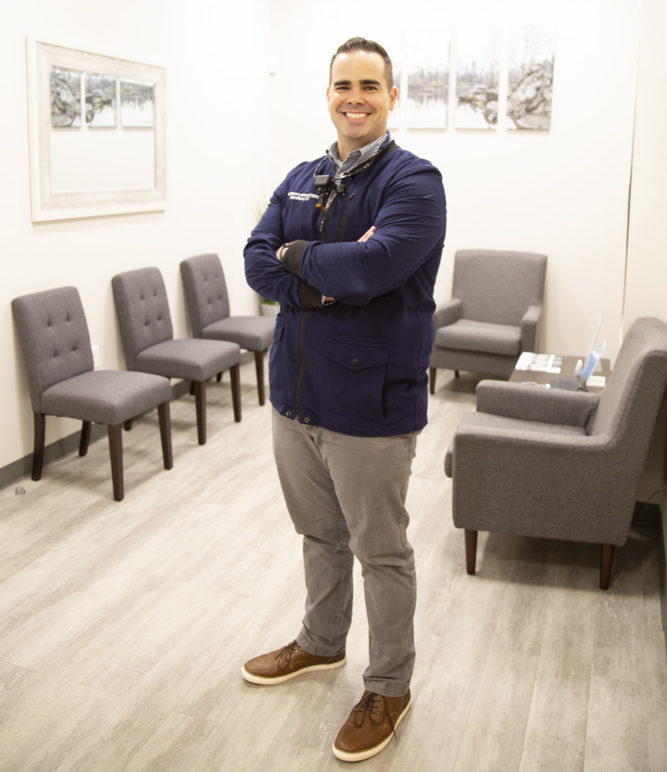 dr matthew lopresti standing arms crossed in lobby