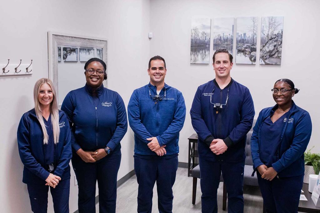 lopresti team members standing together in office