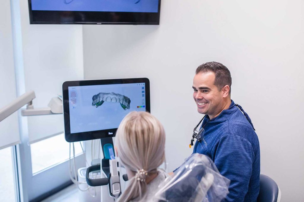 dr showing patient xray of teeth