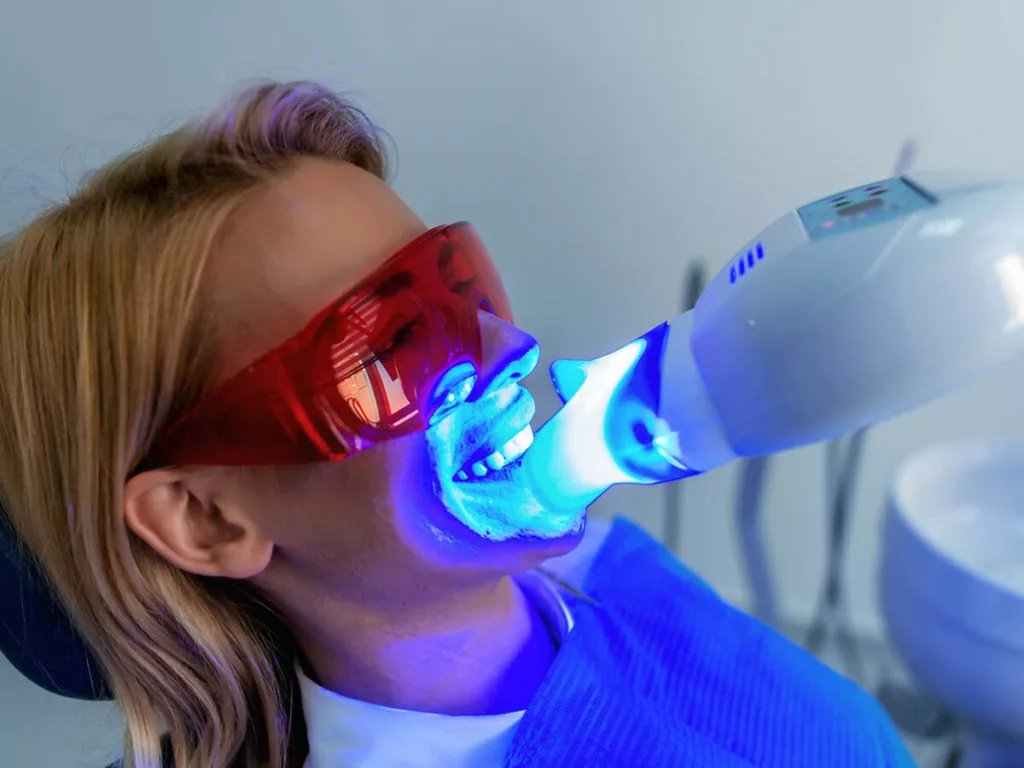 picture of woman getting teeth whitened in dental office